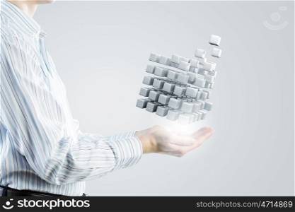 Thinking outside the box as concept. Businessman hand shows cube as symbol of problem solving