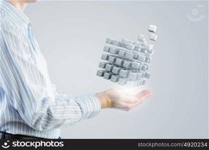 Thinking outside the box as concept. Businessman hand shows cube as symbol of problem solving