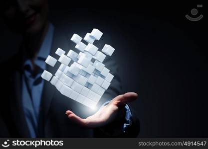 Thinking outside the box as concept. Businesswoman hand shows cube as symbol of problem solving