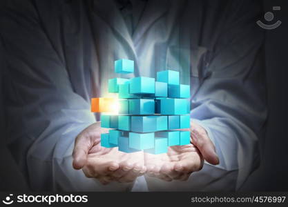 Thinking outside the box as concept. Doctor hands shows cube as symbol of problem solving