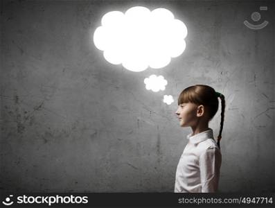 Thinking over something. Girl of school age and speech balloons above her head