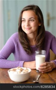 Thinking teenage girl enjoy healthy cereal breakfast looking aside