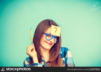 Thinking woman with big nerdy eyeglasses and question mark on forehead. Creating new idea, studying and education concept.. Thinking woman with big eyeglasses and light bulb