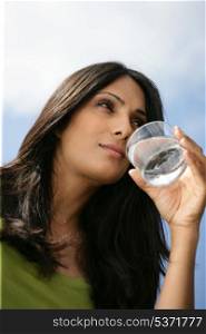 Thirsty woman drinking glass of water
