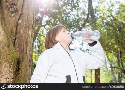 thirsty woman drinking water sunny day