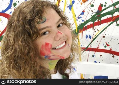 Thirteen year old girl playing with paint.