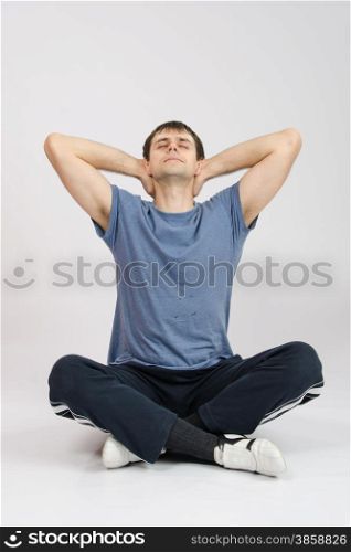 thirty young athletic man does physical exercises