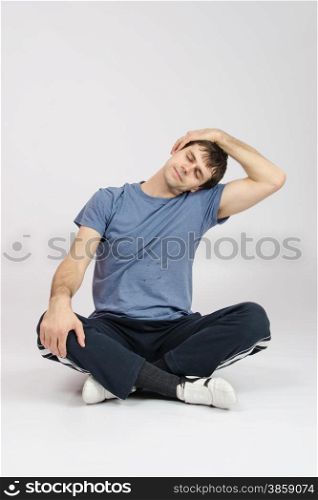 thirty young athletic man does physical exercises. Athlete flexing muscles of the neck