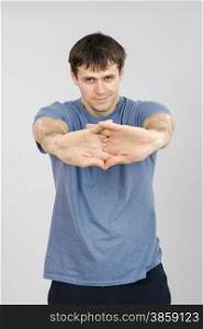 thirty young athletic man does physical exercises. Athlete pulls the arm muscles