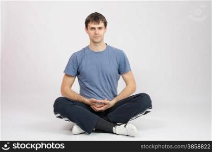 thirty young athletic man does physical exercises. Athlete resting after exercise complex