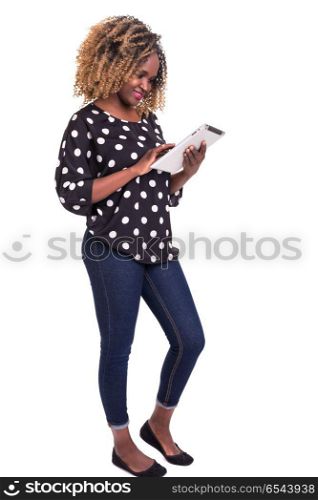 This app looks really nice!. Young african woman working with her tablet computer, isolated over a white background