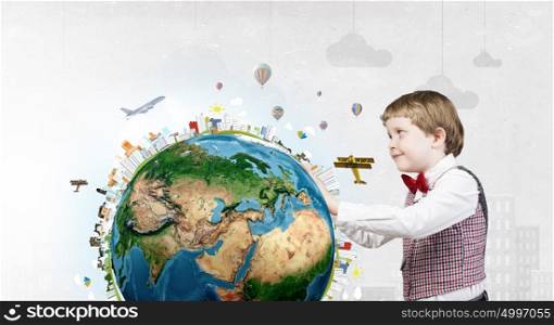This great big world. Cute boy wearing red bowtie exploring planet. Elements of this image are furnished by NASA
