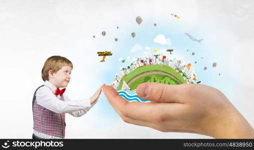 This great big world. Cute boy wearing red bowtie exploring world