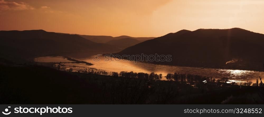 This is a sunset landscape with river in the valley. The IRL location is the bend of Danube in Hungary during a the most higher flood in the past 100 years.