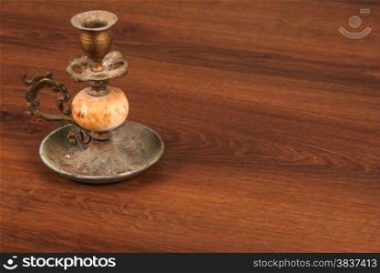 This is a vintage candlestick. And this object used on the wood.