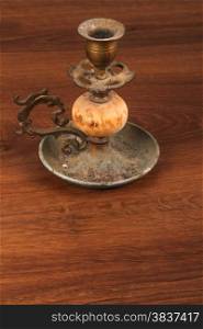 This is a vintage candlestick. And this object used on the wood.