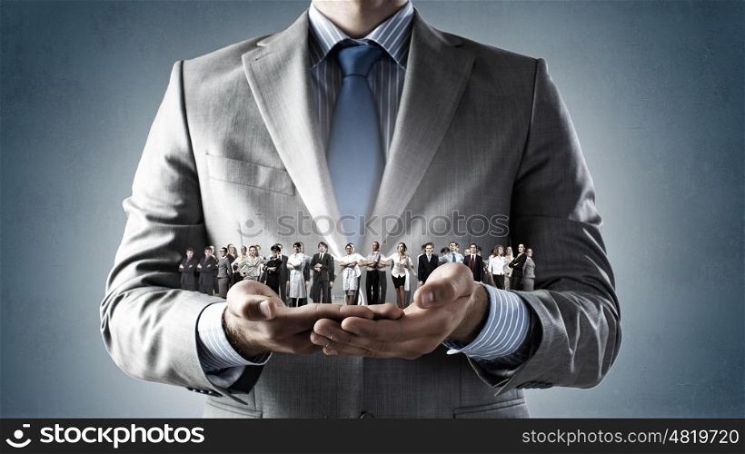 This is my team. Close up of businessman holding in hands successful people of different professions