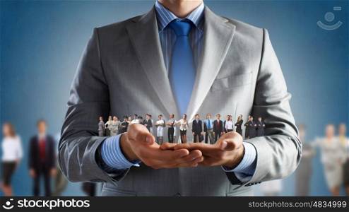 This is my team. Close up of businessman holding in hands successful people of different professions