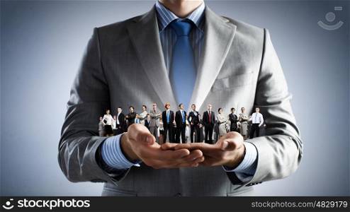 This is my team. Close up of businessman holding in hands successful business team