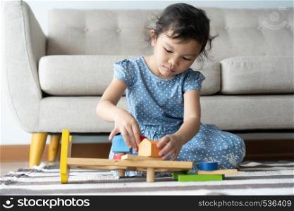 This one asian little girl is playing in the lhome .she smile very happily