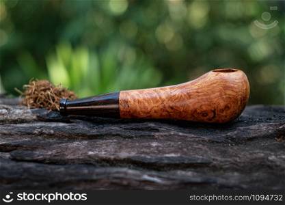 This Tobacco pipe is made from burl wood at white background