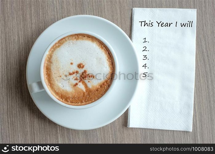THIS YEAR I WILL word with hot cappuccino coffee cup on table background at the morning. New Year New Start, Resolution, Solution, Strategy and Mission concept