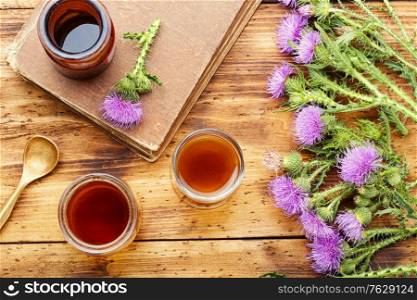 Thistle or silybum in folk herbal medicine.Healing wild herbs.. Milk thistle in herbal medicine