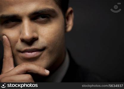 Thoughtful business man over black background