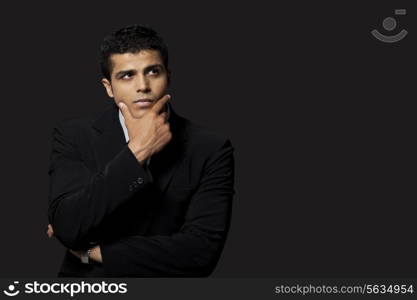 Thoughtful business man over black background