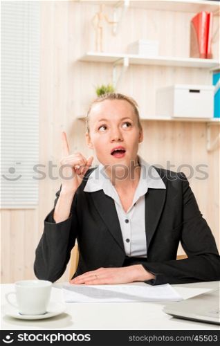 thoughtful business woman in suit in the office
