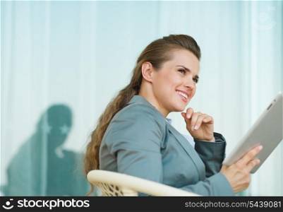 Thoughtful business woman using tablet PC