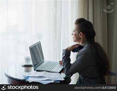 Thoughtful business woman working at hotel room