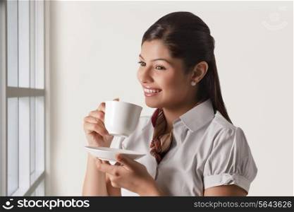 Thoughtful businesswoman having cup of tea for refreshment