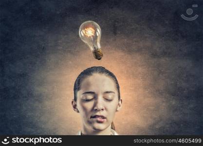 Thoughtful businesswoman. Pensive businesswoman with closed eyes and light bulb above her head