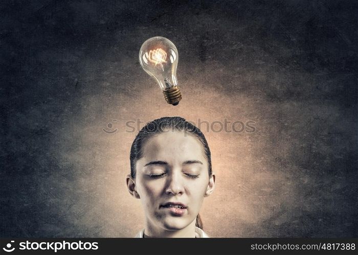 Thoughtful businesswoman. Pensive businesswoman with closed eyes and light bulb above her head