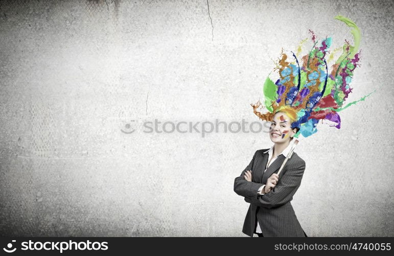 Thoughtful businesswoman with colorful splashes out of her head. Woman with colored head