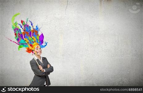 Thoughtful businesswoman with colorful splashes out of her head. Woman with colored head