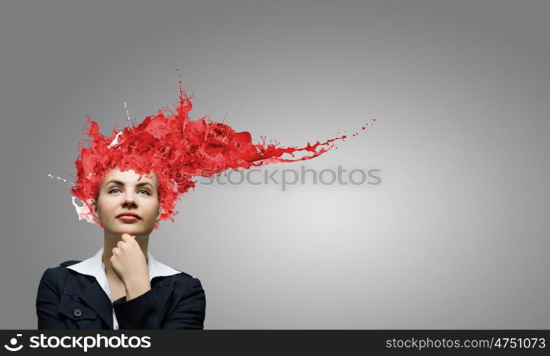 Thoughtful businesswoman with colorful splashes out of his head. Woman with colored head