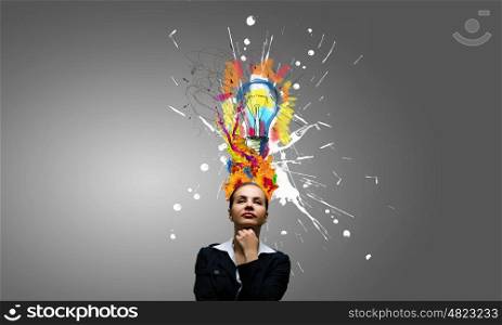Thoughtful businesswoman with colorful splashes out of his head. Woman with colored head