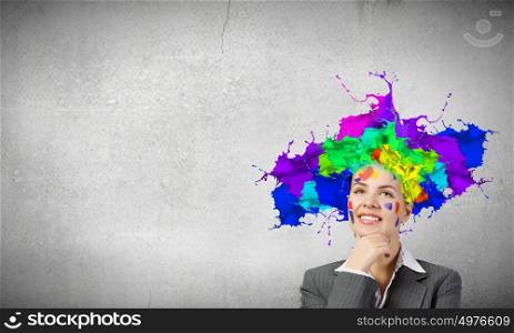 Thoughtful businesswoman with colorful splashes out of his head. Woman with colored head