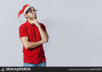 Thoughtful christmas man looking aside. Christmas handsome guy with thoughtful face isolated. Thoughtful man in christmas clothes with hand on chin. Thoughtful christmas man concept