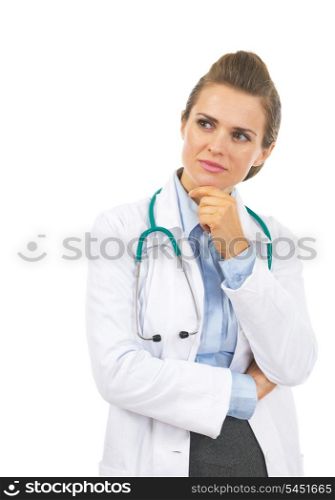 Thoughtful doctor woman looking on copy space