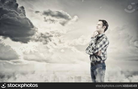 Thoughtful guy. Young handsome man in casual thinking over something