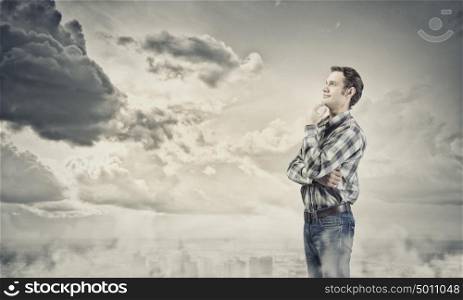 Thoughtful guy. Young handsome man in casual thinking over something