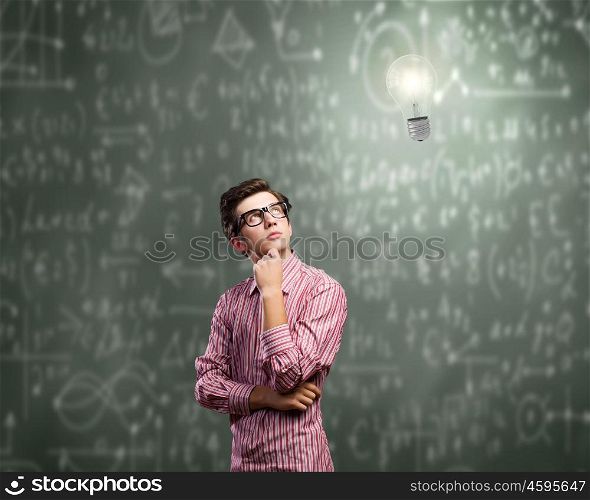 Thoughtful guy. Young thoughtful man in casual against chalkboard