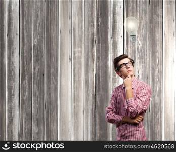 Thoughtful guy. Young thoughtful man in casual against chalkboard