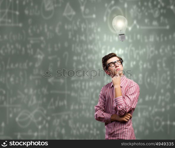 Thoughtful guy. Young thoughtful man in casual against chalkboard