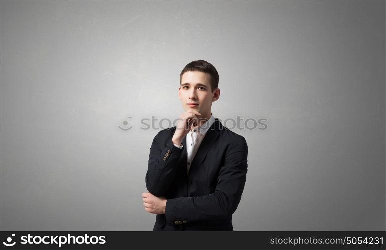 Thoughtful handsome guy. Young man in black jacket looking thougtfully in camera like making decision