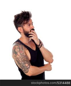 Thoughtful handsome man with tattoos isolated on a white background