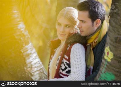 Thoughtful loving couple looking away in park